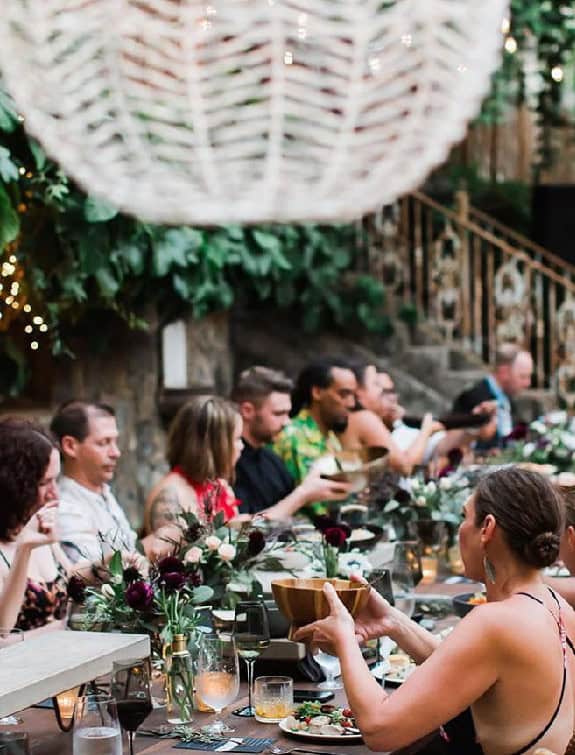 Guests enjoying a sophisticated dinner party with elegant decor and fine dining at Cutting Edge Catr.