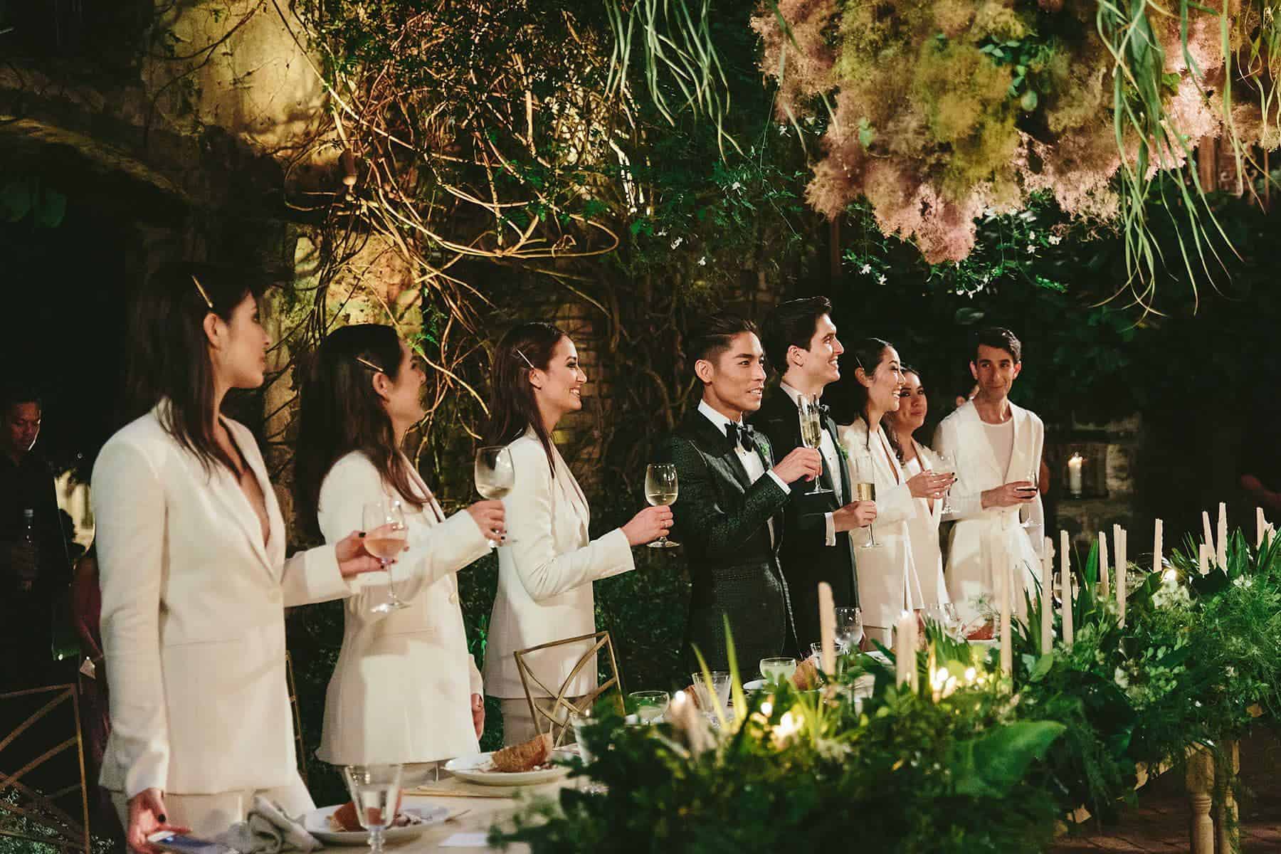 Guests enjoying a sophisticated catering event with fine dining and floral decor.