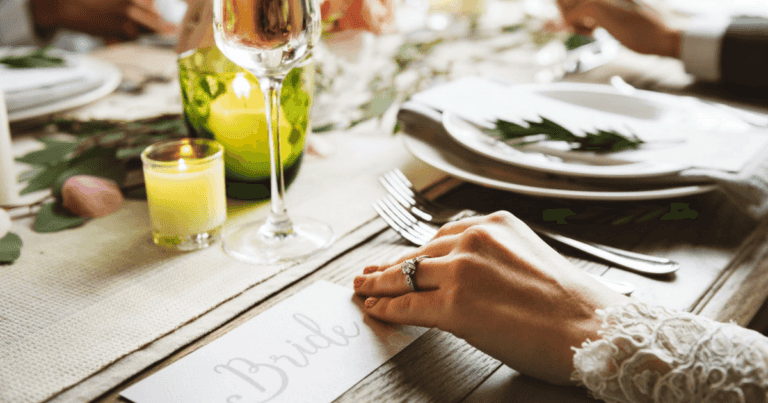 Beautiful wedding table setup with candles, greenery, and fine dining ware in Maui.